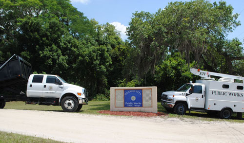 Picture of Public Works sign and two Public Works Vehicles